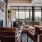 Leasing lounge area with seating next to a fireplace and cityscape views